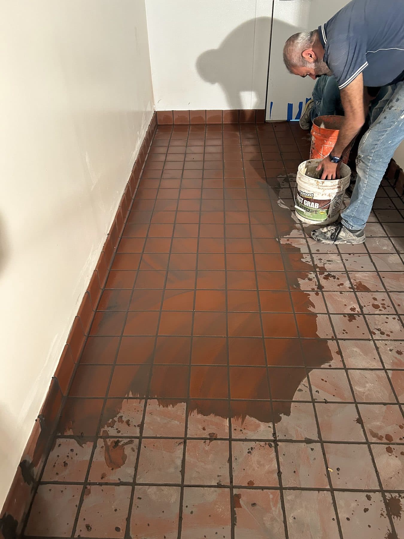 Tile floor being grouted at the Moorpark Street project.